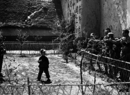 American and Chinese servicemen exchanging a "Ding Hao" thumbs up with a young Chinese boy the CBI. 