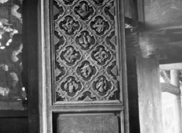 Traditional woodwork on door panels in China. During WWII.