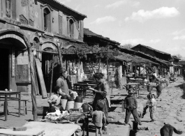 Local people in a village in Yunnan province, China: A quiet market street near Kunming on a non-market day. During WWII.