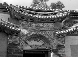 Architecture in Yunnan province, China during the Second World War: An ornate entry door to a home compound, during WWII.  From the collection of Eugene T. Wozniak.