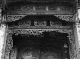 Wood carvings around the door of a compound that has been taken over for use by the Nationalist government. Architecture in Yunnan province, China.