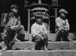 Local people in China: Chinese boys sitting before incense burner. During WWII.