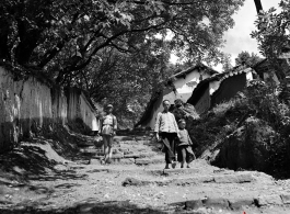 Local people in China: Villagers in Yunnan walk a village path.  From the collection of Eugene T. Wozniak.