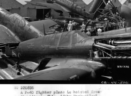 May 24, 1944  A P-40 fighter plane is hoisted from the Liberty Ship, "John Dockweiler", which brought fifteen planes from the U. S. to Karachi, India.  All of the planes were hoisted from the ship in slightly over an hour, during WWII.  Photo by Tec Sgt Roy J. Yarnell.