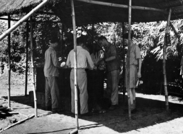 Enlisted men wash their mess kits in cans of scalding water at the Kurmitola Army Air Base in India in 1943.   In the CBI during WWII.