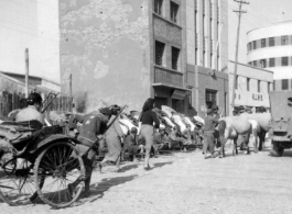 Scenes around Kunming city, Yunnan province, China, during WWII: Street and lined up rickshaws.