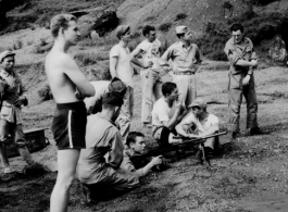 Firing Sten gun in Kweilin (Guilin, Guangxi province, China) during WWII.  Sigmeir prone, Seidler on right after shooting gun.