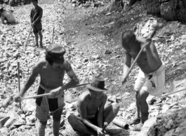 Laborers breaking stone by hand tools in southwest China, during WWII.