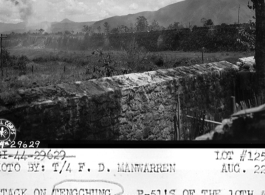 The allied attack on Tengchong (Tengchung) in Yunnan province, China, during WWII, showing the city wall. Note American P-51 in flight.   Photo by F. D. Manwarren.