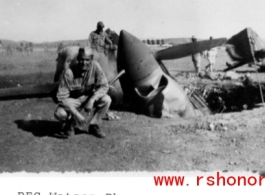 GI kneels before destroyed P-40 fighter in the CBI.  Photo from PFC Watson.