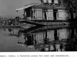 A boat on the water at Kashmir, India, during WWII, and Smitty, center on deck, buying trinkets or fruit from the bum boat.  Photo from Robert T. Keagle.