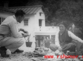 A GI talks to a local woman in the Himalayas, probably negotiating over prices for wares.    From "P. Noel" showing local people and scenes around Mussorie, India.    In the CBI during WWII. 