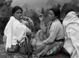 Three ladies smoke on a cold day at the rest camp at Darjeeling. During WWII.