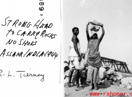 A woman carries rocks on her head in Assam, India, during 1944.  Photo from R. L. Tierney.