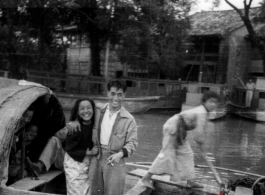 Young Chinese family in a boat travels by, during WWII.