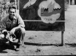 Gordon Brown kneels before 16th Fighter Group Sign At Chenggong (Chengkung), 15 miles from Kunming, during WWII. In Chinese the sign says "Great Wall In The Air" ("空中长城").  Photo from Gordon Brown.