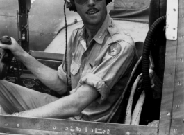 A GI sits in the cockpit of an airplane in the CBI during WWII. Kesterson.