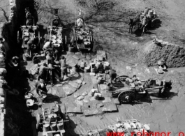 Chinese men with carts collect water at a large local well, and draw water for delivery, probably in northern China.