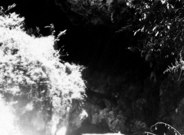 Karst cliffs overhanging road north of Kunming, May 1945.