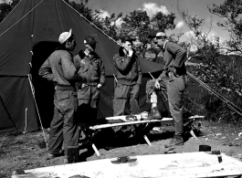 GIs talk and smoke in front of a tent at Qingshuihai lake.