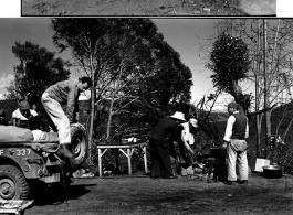 Life around the camp, including the business of cooking a meal over the open fire--Notice that a number of Chinese men are helping with the fire and meal.  Presumably these are staff from the Yangkai airbase who have come along to help.