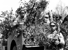 Chinese soldiers with equipment ready and covered in camouflage during exercises in southern China, in Yunnan province.  Despite the appearance of being on their way to battle, these men are more likely in fact prepared for a demonstration or honor parade. 