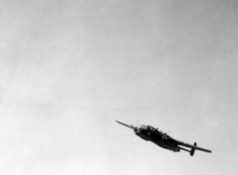 B-25 Mitchell bomber in flight in the CBI, in the area of southern China, Indochina, or Burma.