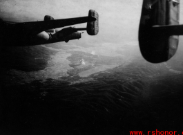 Smoke rises on the ground behind B-25 #440 after an attack by American B-25s, likely in SW China, fairly close to Tengchong.  An image from the collection of Eugene T. Wozniak. 