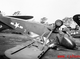 A small aircraft, a Stinson L-5 Sentinel, tail number #416889, flipped over after a tornado on the flight line at Shamsernasar, Assam. A C-64, tail number #35302, is tipped into a ditch behind it. (Thanks to jbarbaud for additional information!)   From the collection of David Firman, 61st Air Service Group.