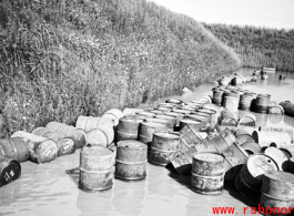 Fuel barrels in a flooded revetment in Yunnan province, China, most likely at the Luliang air base area. During WWII.