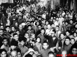 A wonderful image from the Walter S. Polchlopek collection--a local crowd, probably in the county seat not far from Yangkai (Yangjie) air base in Yunnan province, China, enjoying the entertainment of inscrutable foreigners doing funny things in public, that is, they are enjoying the public goofing around by the photographer who is stand raised above the crowd, maybe simply on an American jeep (as in the entry here).  Some expressions (below) really speak to the nature of the interaction.