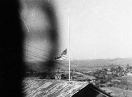 An American flag at half-mast in the barracks area at an American base in Yunnan, China, during WWII.