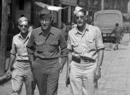 American GIs walking down the road in China during WWII, probably in Yunnan province (based on the architecture in the background). On the right is Frank G. Ehle.