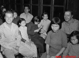 Chaplain Mengel lead his men to participate in outreach to the wartorn and impoverished Chinese countryside. These photos from Chaplain Mengel's private collection, show him with General Chennault, giving out donations from the US airmen. A collection had been taken to help rebuild bombed villages. They also visited mission schools, and assisted blind children's homes. Above, American soldiers interact with blind children.