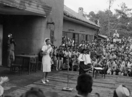 Celebrities (including Ann Sheridan in this shot) perform on an outdoor stage set up at the "Last Resort" at Yangkai, Yunnan province, during WWII. Notice both Americans and Chinese in the audience for this USO event.