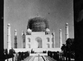 Taj Mahal under repair.  Scenes in India witnessed by American GIs during WWII. For many Americans of that era, with their limited experience traveling, the everyday sights and sounds overseas were new, intriguing, and photo worthy.