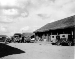 Parked jeeps and transport vehicles, Burma or SW China.