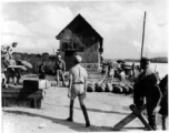 Soldiers of the 14th Air Force, aided by Chinese soldiers and workers, remove bombs from the ammunition dump preparatory to abandoning the Hengyang Airfield.