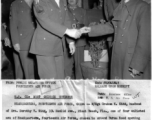 Graham K. Kidd was one of four enlisted men of Headquarters of the 14th Air Force chosen to attend Burma Road opening celebration dinner, and shaking hands with General Lung Yun. The American soldier behind them is M/Sgt. Richard L. Hapgood.