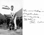 GI restrains his war dog in Ramgarh, India, during WWII. The sign behind him seems to say, "War Dog Detachment Camp."  Photo from Lyle Collver.