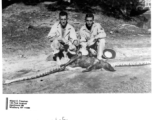 GIs pose with a snake that ate a large mamal.  Photo from Albert E. Freeman.