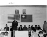 Colonel Tex Hill addresses a crowd on June 29th, 1944, while Madam Chiang Kai-shek looks on.
