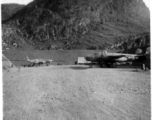 "The Latest In Shops And Equipment--This a picture looking into a revetment that served as our work area and engineering area at Luichow [Liuzhou], China. Lt. Sohl's office was in the little shack at the right and all our tools and equipment was in the tent. We changed a lot of B-24 engines in this revetment along with replacing blown out tires and doing sheet metal repair work. We worked here until the Japanese forced us to evacuate the base and return to Luliang." Caption courtesy of Elmer Bukey.