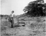 A GI points to detail at Japanese training ground in Rangoon, Burma, during WWII.