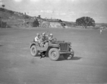 Chinese soldiers drive American jeep in northern China during WWII.