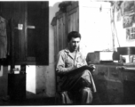 Fernand Arel, writing in the barracks, in with Daggett and Bates, Yangkai, China July 1944.