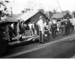 GIs of 7th Veterinary Company pose with mess gear in front of tents in the CBI during WWII.