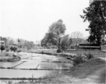 A village and flooded rice paddy in Yunnan province, China. During WWII.