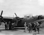 A shark-mouth B-24, the mouth having a unique curl at the back, in a revetment in SW China, likely Sichuan, during WWII. This is a later model B-24 as indicated by the nose turret with two .50 cal machine  guns.