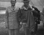 Chennault and Stilwell pose together in front of wing of transport airplane in Yunnan, China, during WWII.